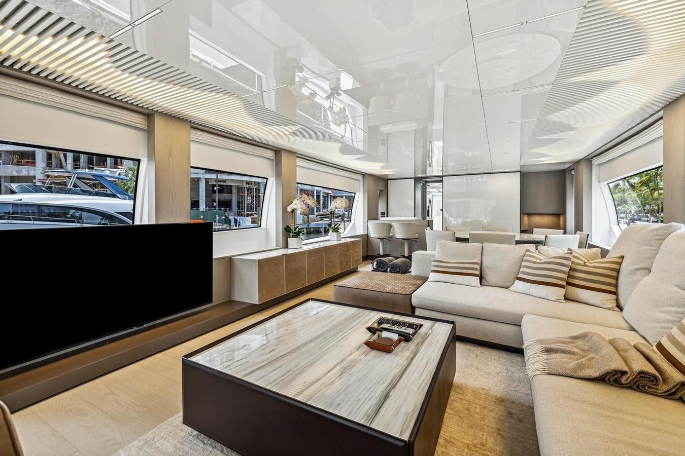a living room with a large screen aboard XFAF8532J021 Yacht for Sale