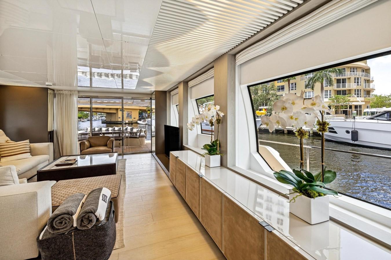 a room with a large window and a table with chairs and plants aboard XFAF8532J021 Yacht for Sale