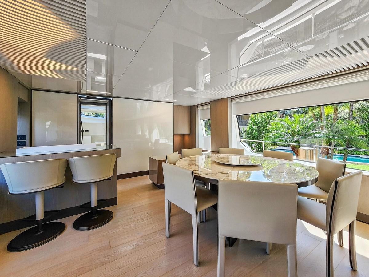 a room with tables and chairs aboard XFAF8532J021 Yacht for Sale