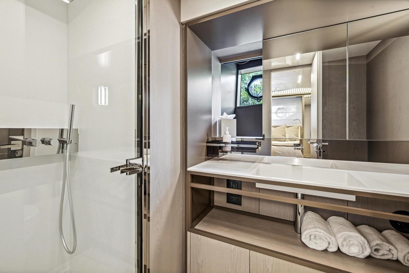 a bathroom with a large mirror aboard XFAF8532J021 Yacht for Sale
