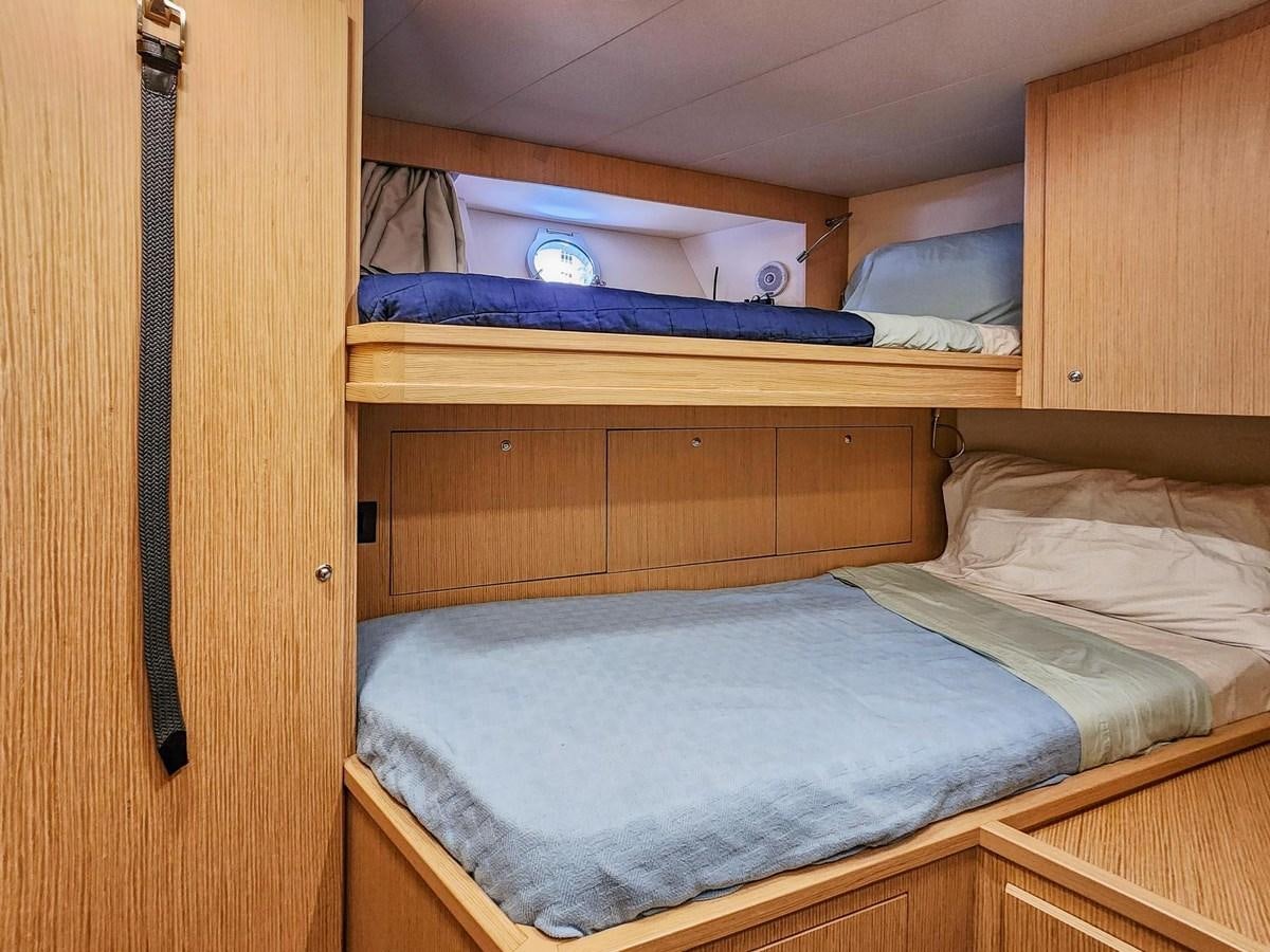 a bed with a wood headboard aboard XFAF8532J021 Yacht for Sale