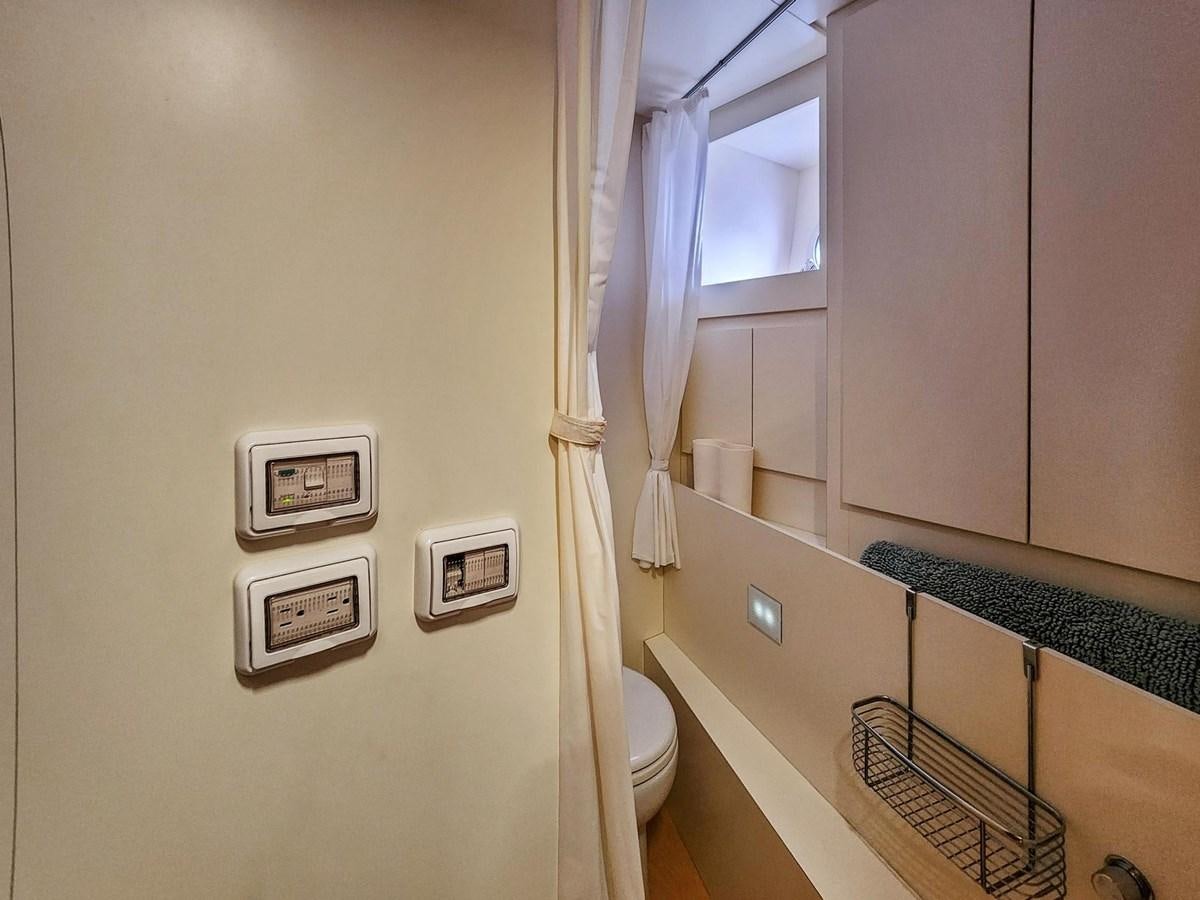 a bathroom with a toilet and a laundry basket aboard XFAF8532J021 Yacht for Sale