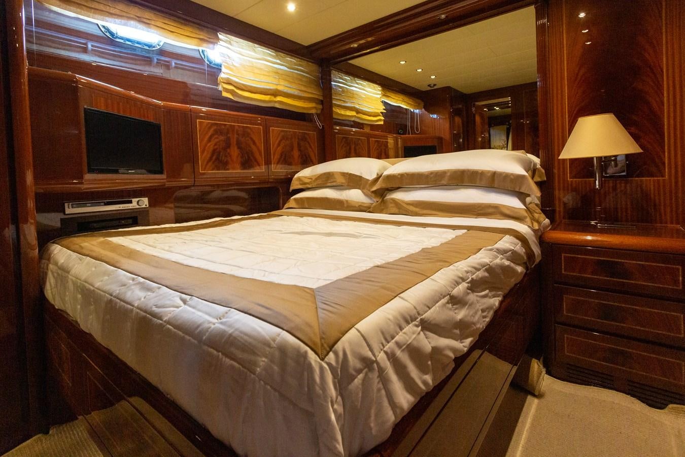 a bed with a television on the wall aboard STAND BY ME Yacht for Sale