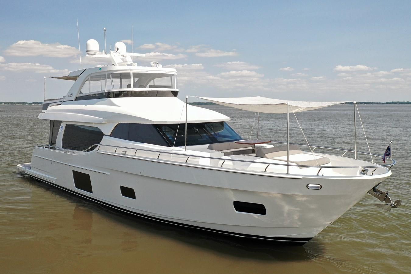 a white yacht on a beach aboard 70E Yacht for Sale