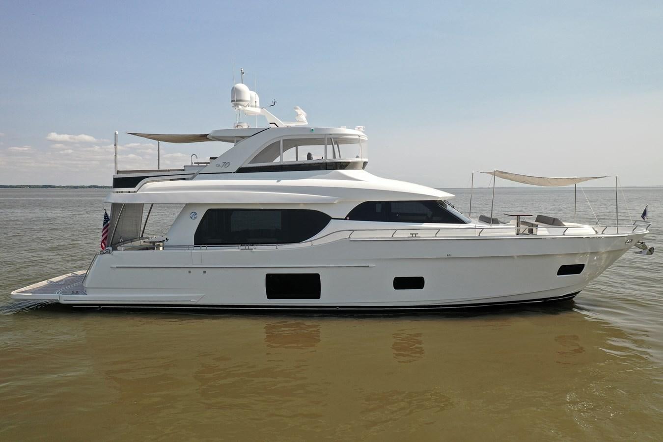 a white yacht on the water aboard 70E Yacht for Sale