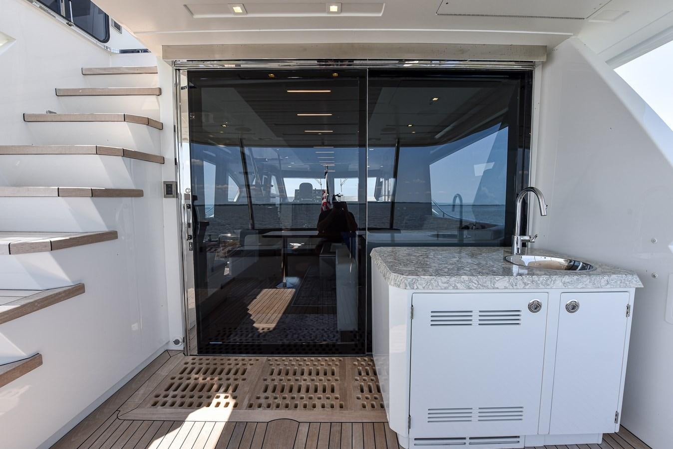 a kitchen with a large glass door aboard 70E Yacht for Sale