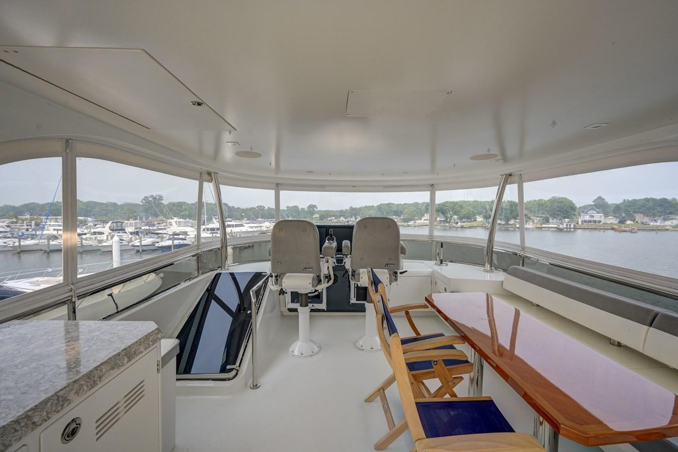 a boat with chairs on the deck aboard 70E Yacht for Sale