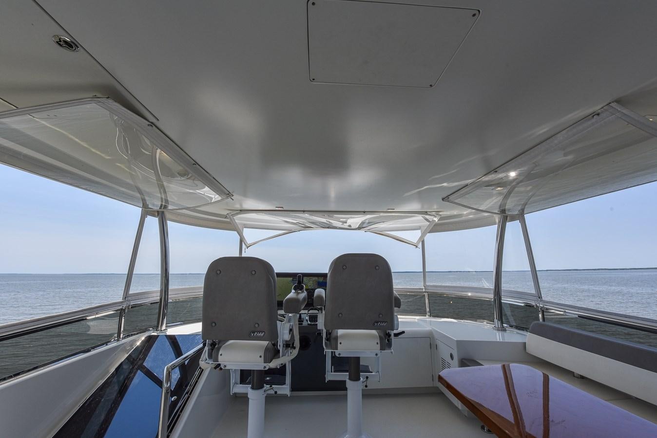 a boat with chairs on the deck aboard 70E Yacht for Sale