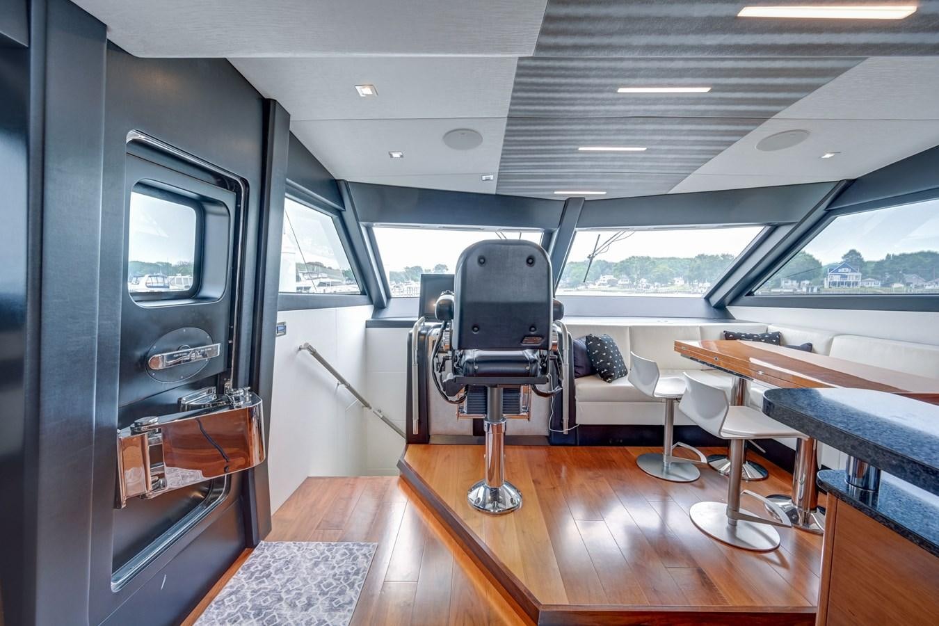 a room with a table and a chair aboard 70E Yacht for Sale