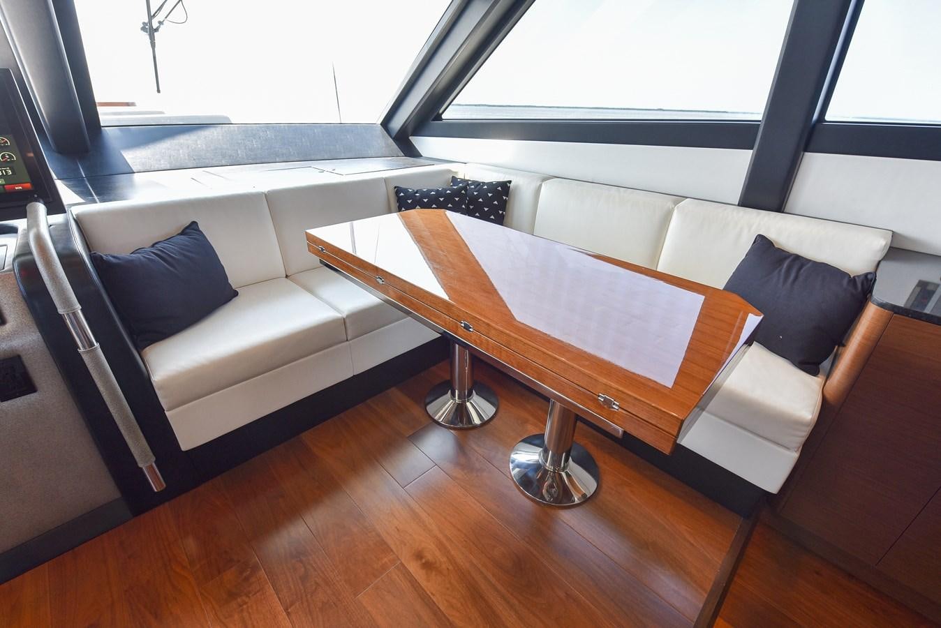 a living room with a couch and a coffee table aboard 70E Yacht for Sale