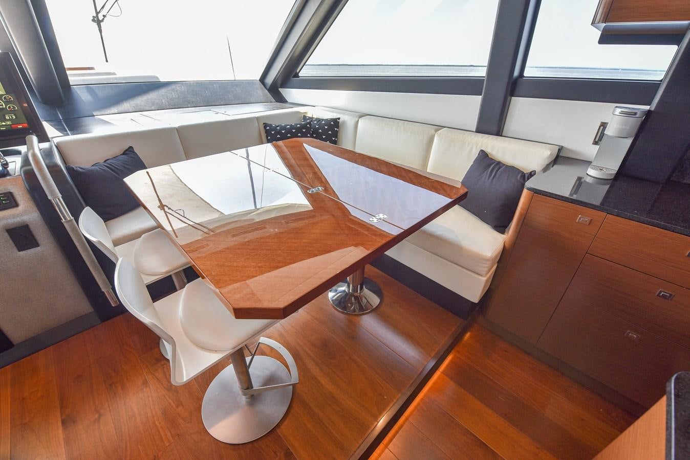 a room with a table and chairs aboard 70E Yacht for Sale