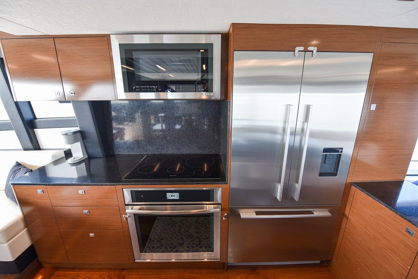 a kitchen with stainless steel appliances aboard 70E Yacht for Sale