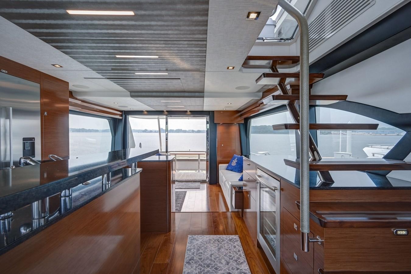 a room with wood floors and wood cabinets aboard 70E Yacht for Sale