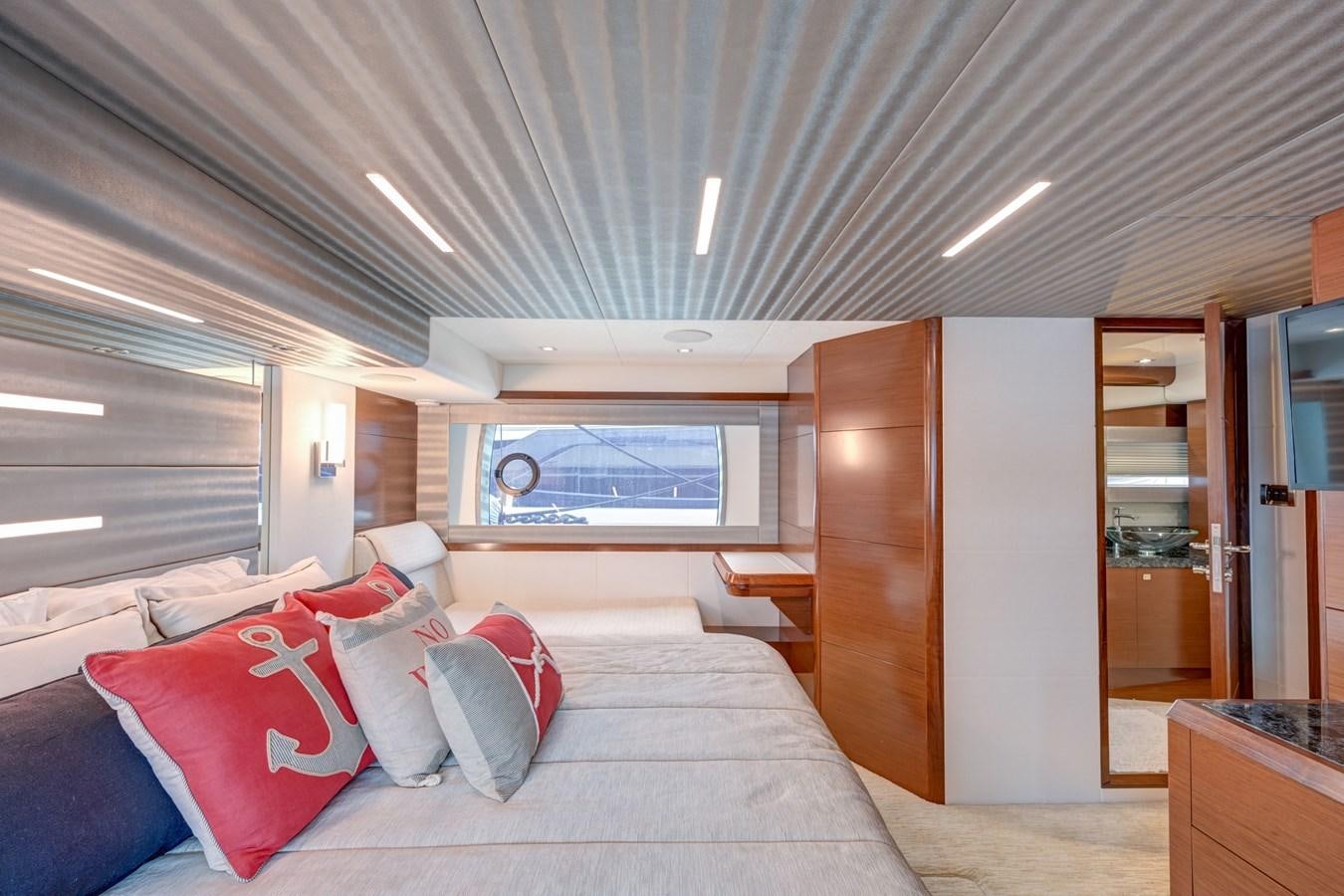 a room with a bed and a window aboard 70E Yacht for Sale