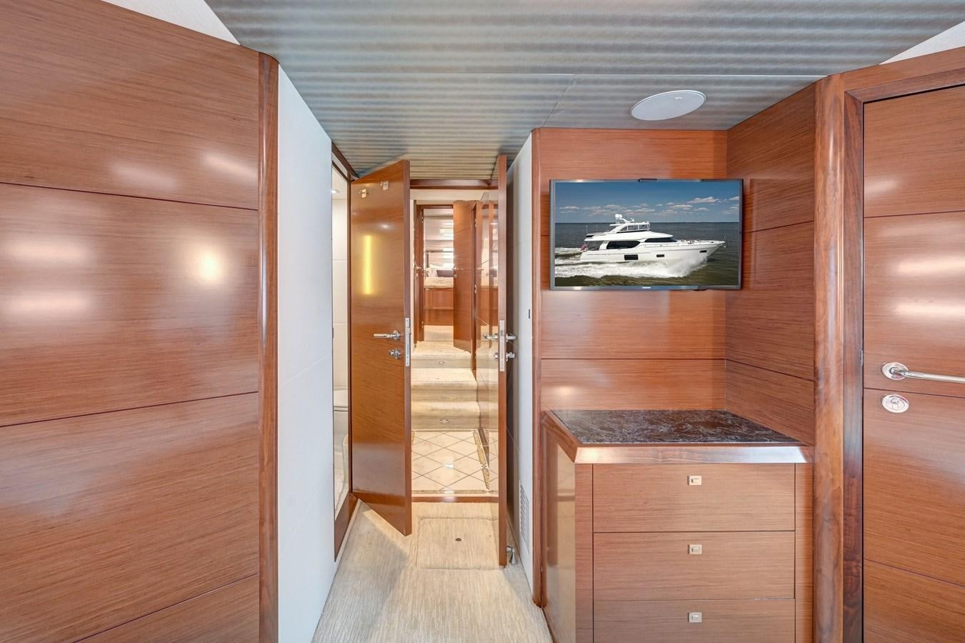 a room with a wood cabinet and a wood door aboard 70E Yacht for Sale