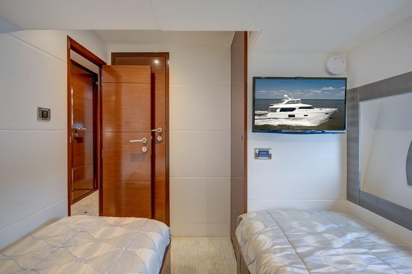 a bedroom with a bed and a door aboard 70E Yacht for Sale