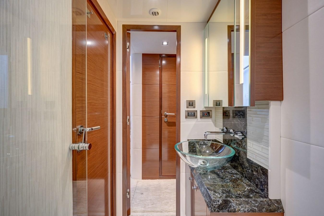 a bathroom with a sink and a mirror aboard 70E Yacht for Sale