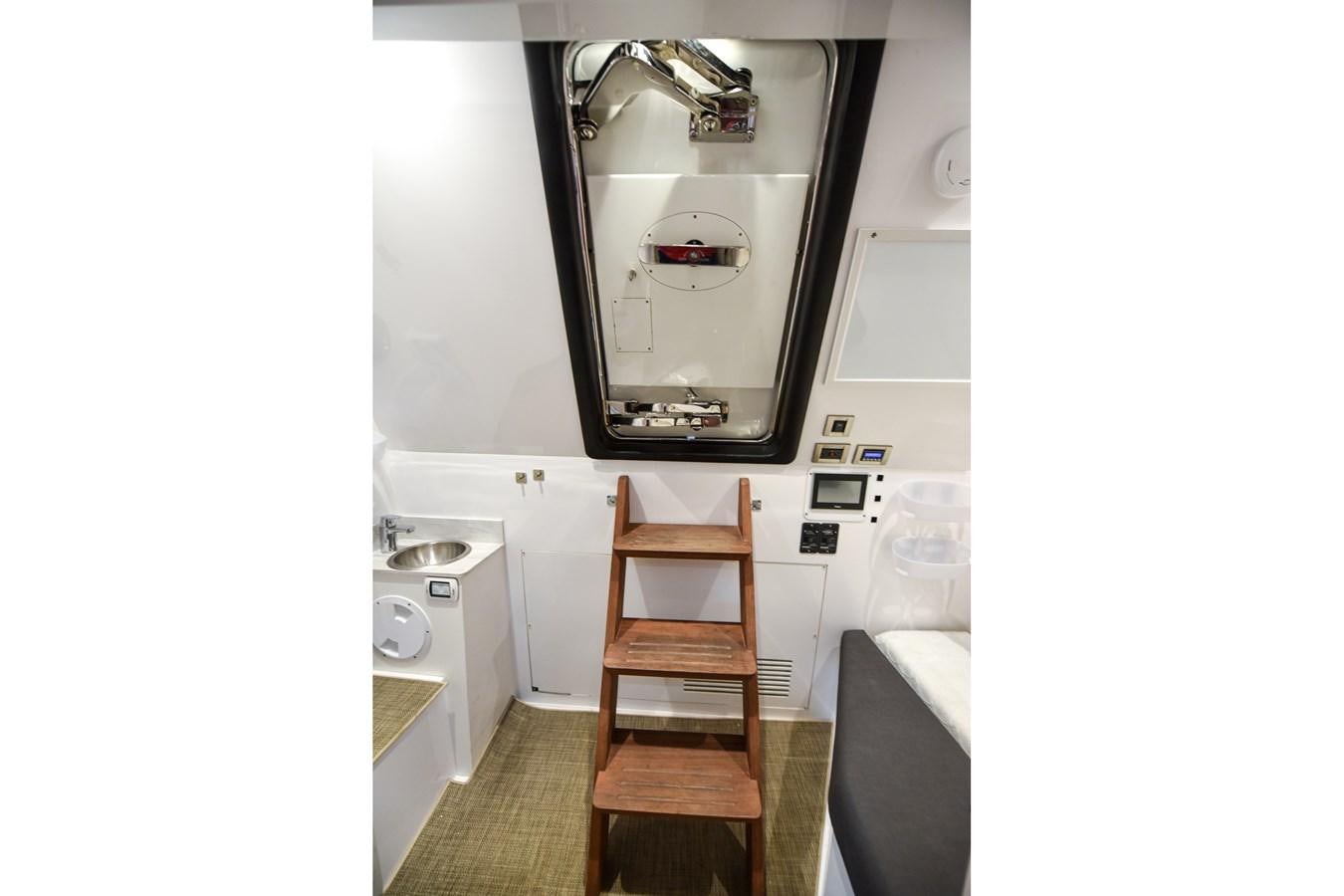 a chair and a sink in a bathroom aboard 70E Yacht for Sale