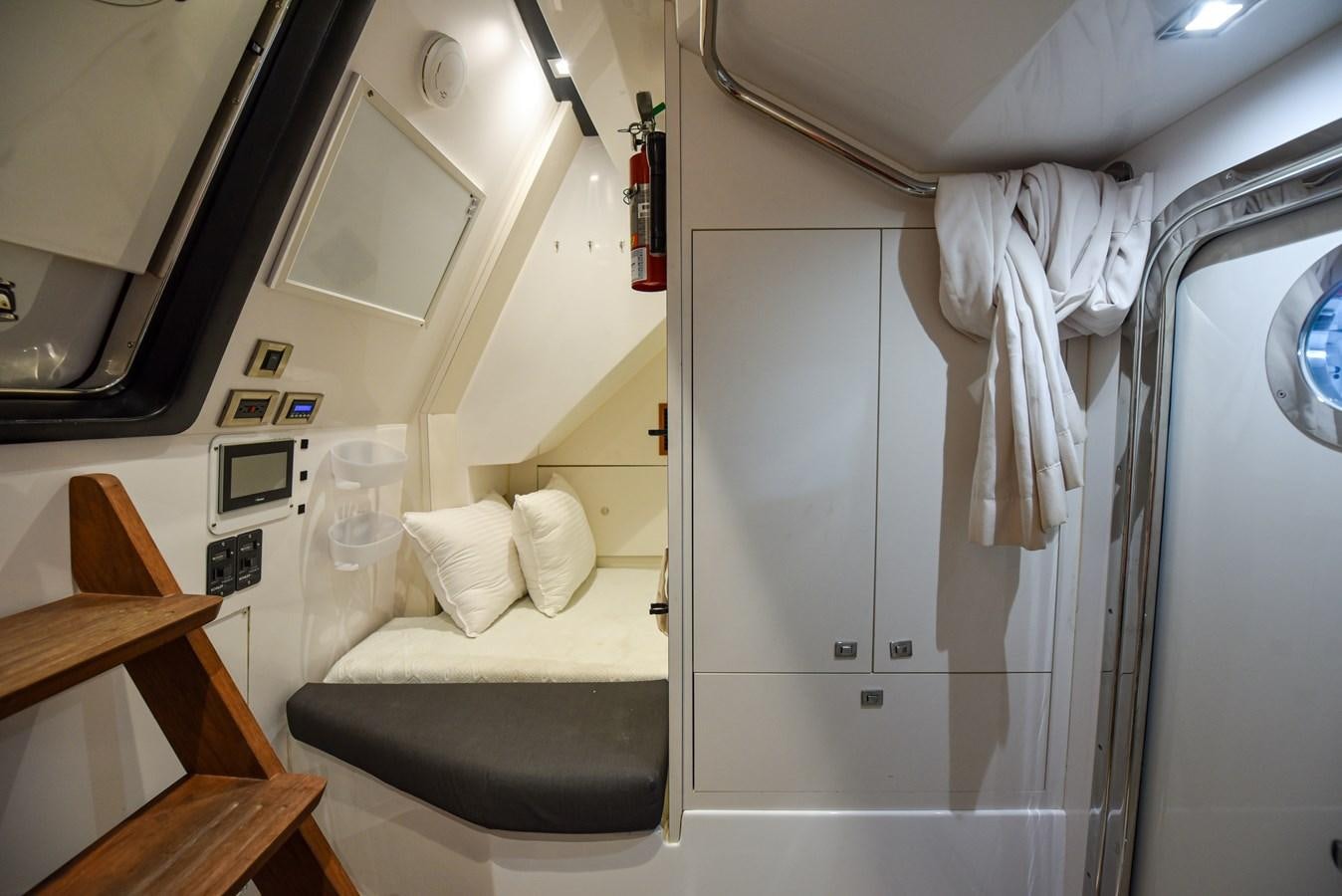 a small room with a bed and a table aboard 70E Yacht for Sale