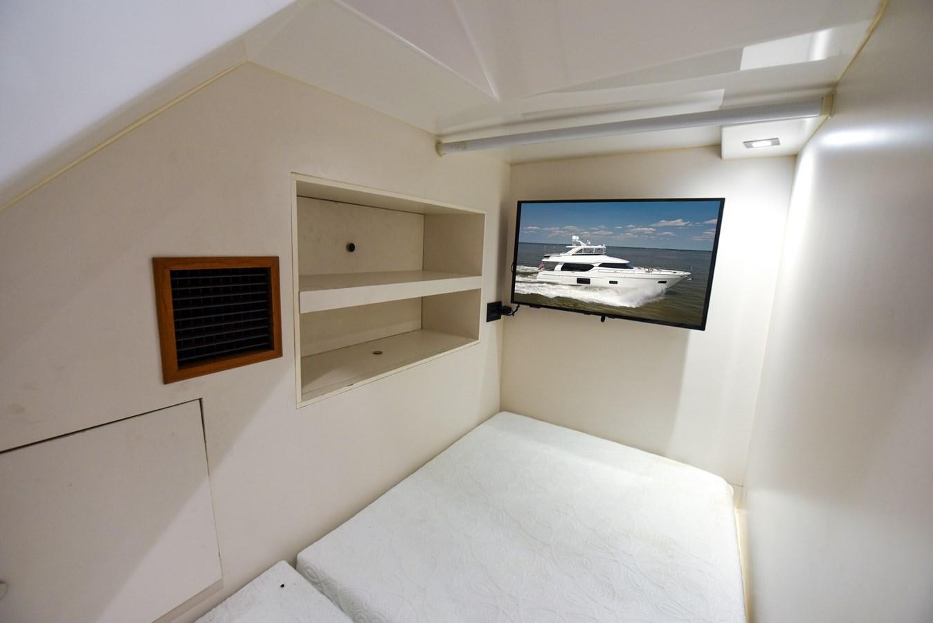 a room with a television and a bed aboard 70E Yacht for Sale