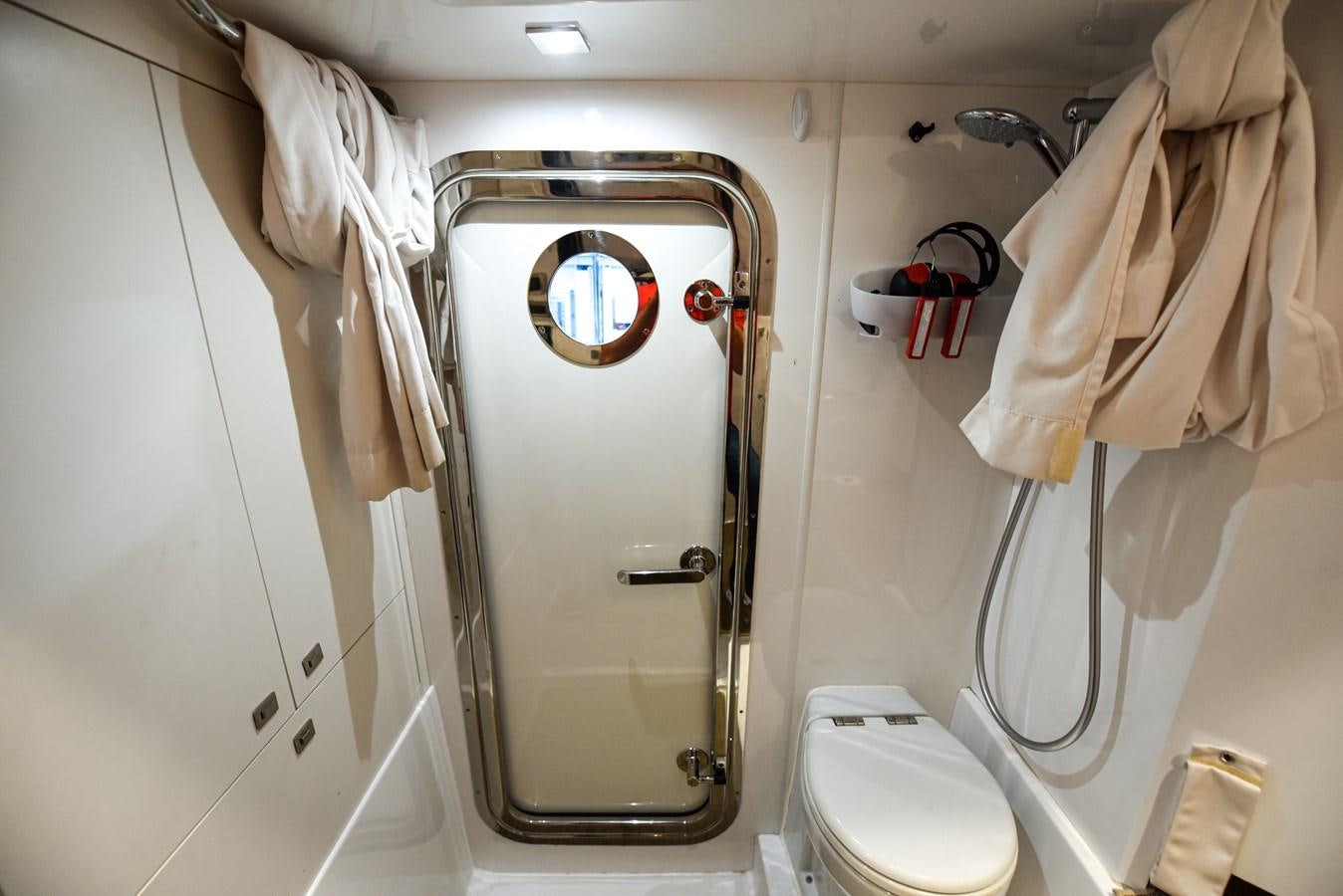 a bathroom with a toilet and a sink aboard 70E Yacht for Sale