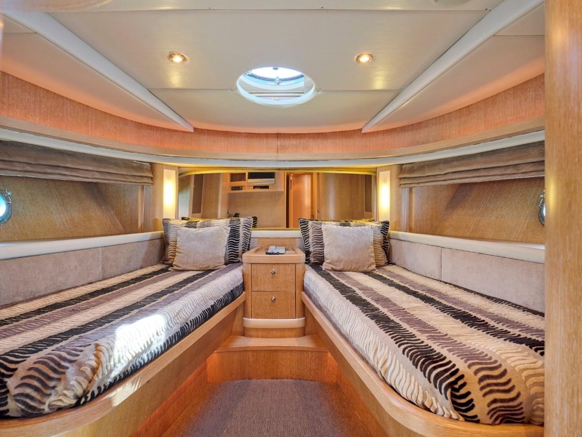 a room with a bed and a desk aboard HUNTING STAR Yacht for Sale