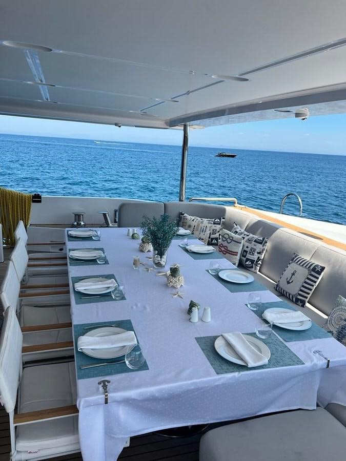 a table with plates and dishes on it aboard LOVE T Yacht for Sale