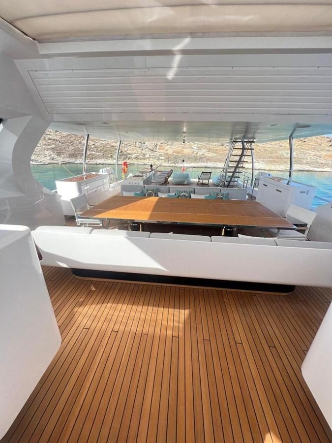 a room with a deck and a view of the water aboard LOVE T Yacht for Sale