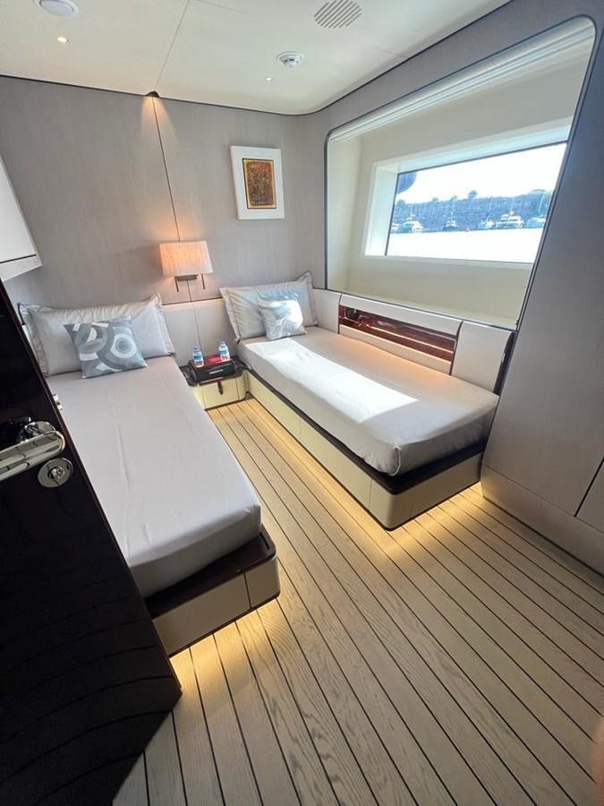 a bedroom with a bed and a desk aboard LOVE T Yacht for Sale