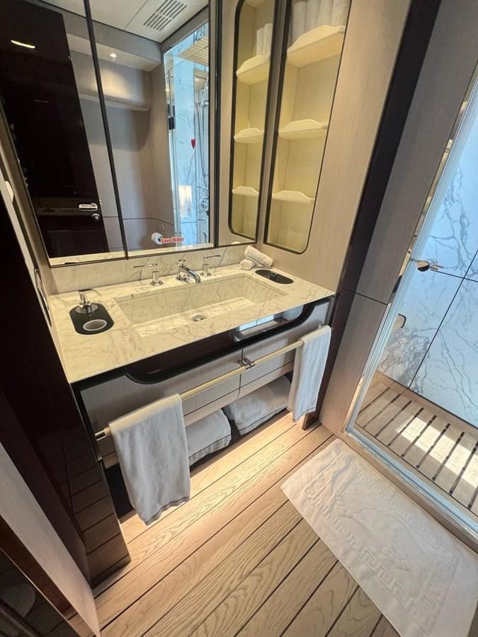 a bathroom with a large mirror aboard LOVE T Yacht for Sale