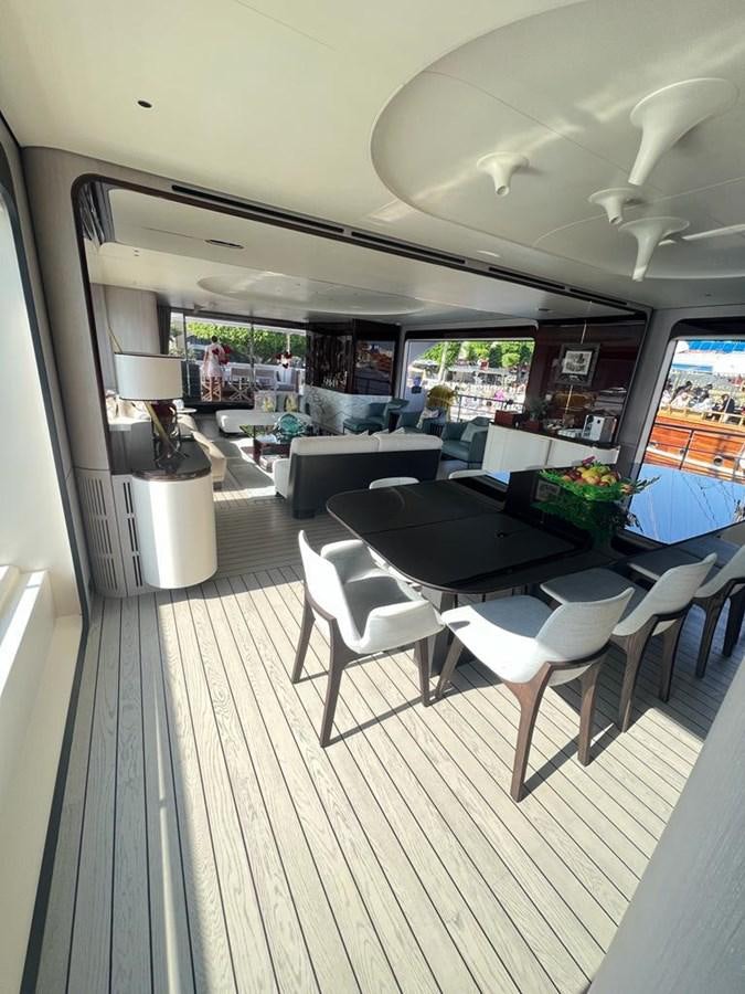 a room with a table and chairs aboard LOVE T Yacht for Sale