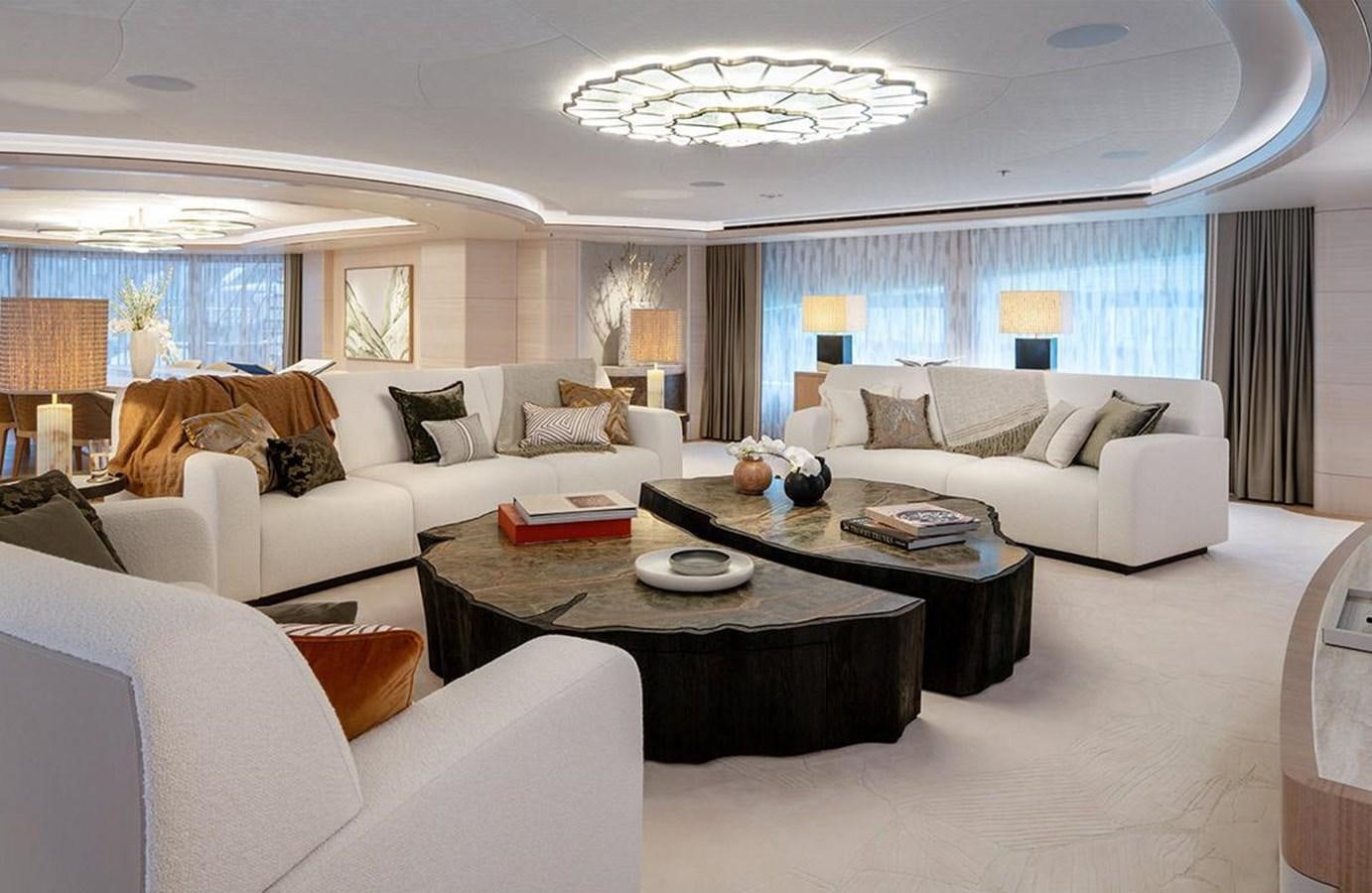 a living room with white couches and a table aboard SPARTA Yacht for Sale