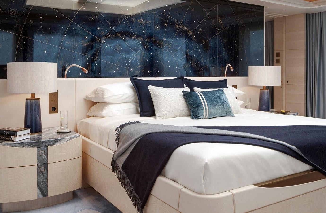 a bed with a blue and white bed spread aboard SPARTA Yacht for Sale