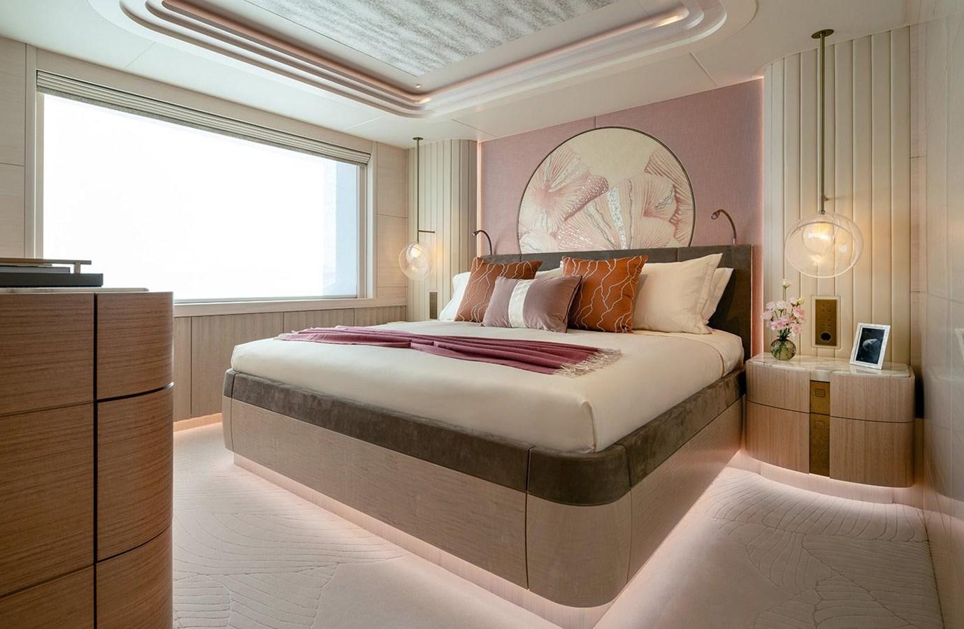 a bed with a pink comforter aboard SPARTA Yacht for Sale