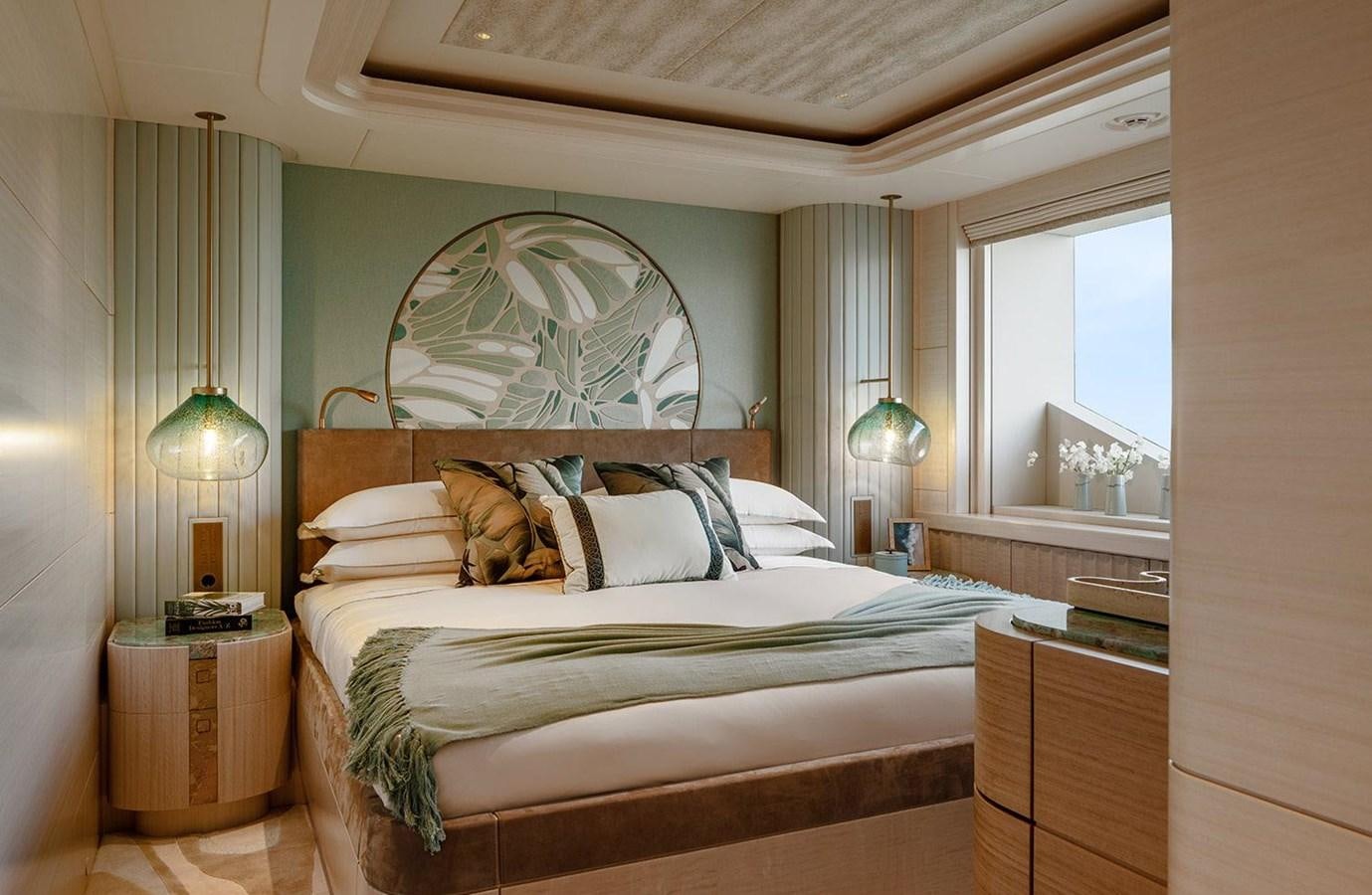 a bed with a painting on the wall aboard SPARTA Yacht for Sale