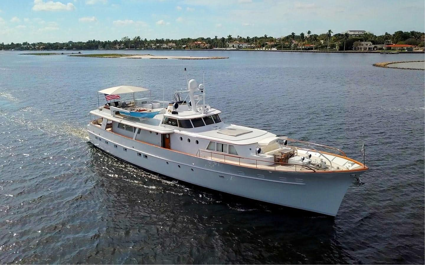 a white boat on the water aboard SOVEREIGN Yacht for Sale