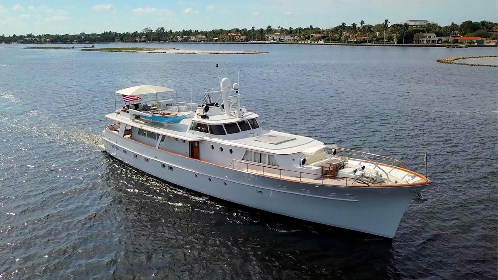 a white boat on the water aboard SOVEREIGN Yacht for Sale