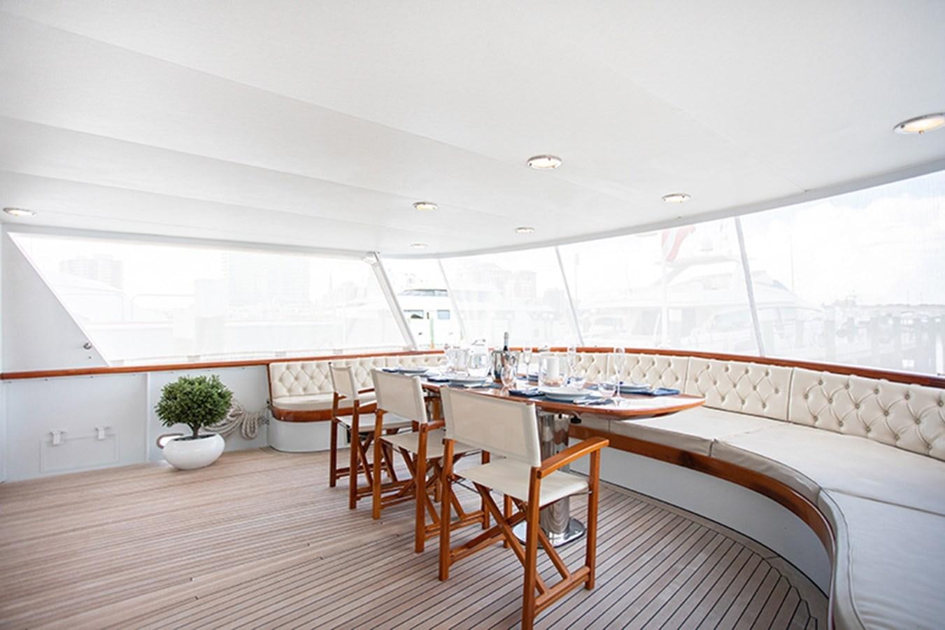 a room with a table and chairs aboard SOVEREIGN Yacht for Sale