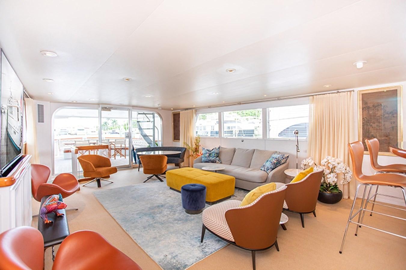 a living room with a couch and chairs aboard SOVEREIGN Yacht for Sale