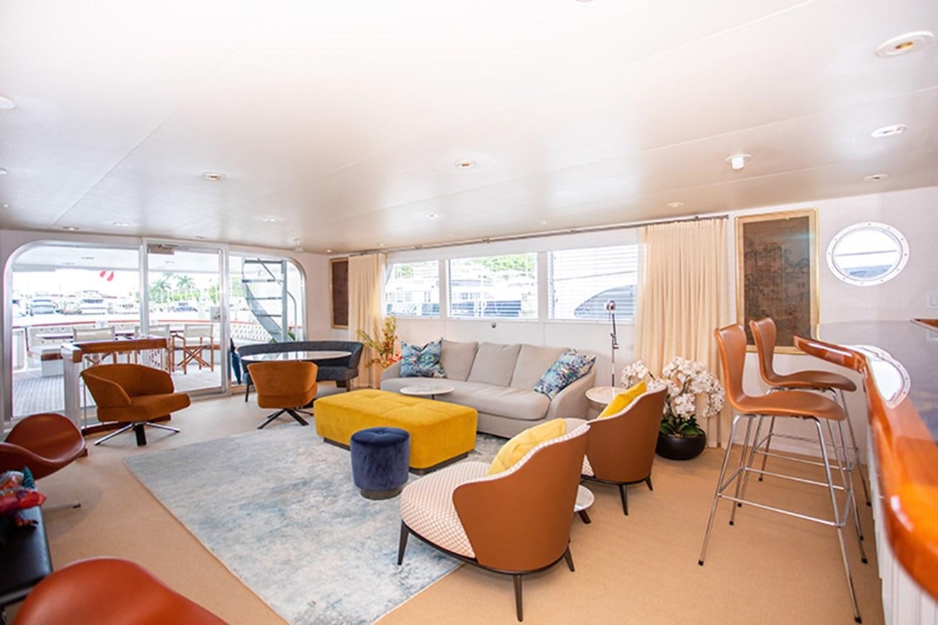 a living room with a couch and a table aboard SOVEREIGN Yacht for Sale