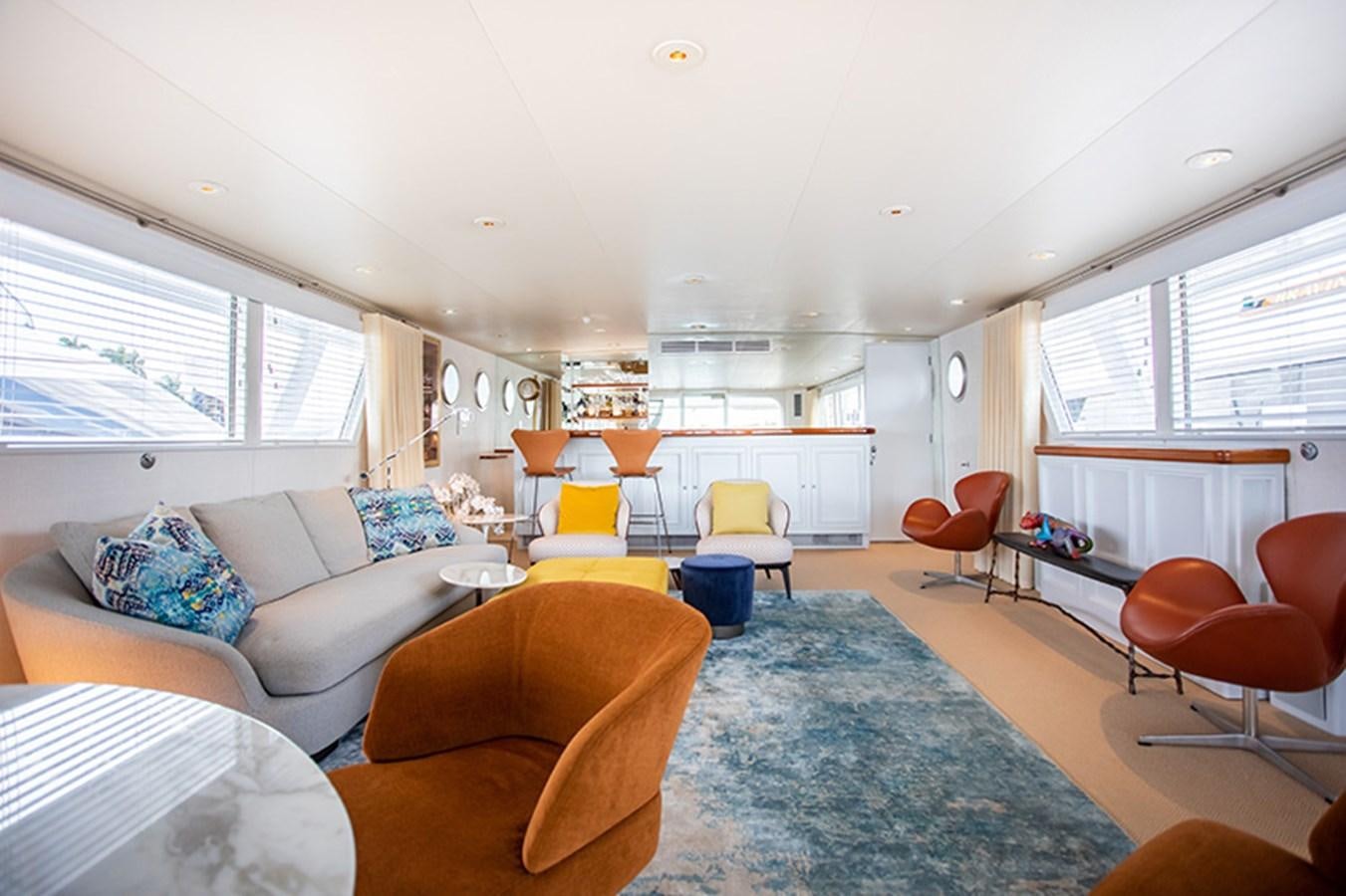 a living room with a couch and chairs aboard SOVEREIGN Yacht for Sale