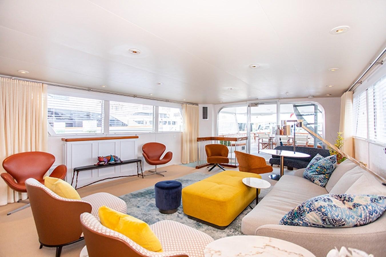 a living room with a large window aboard SOVEREIGN Yacht for Sale