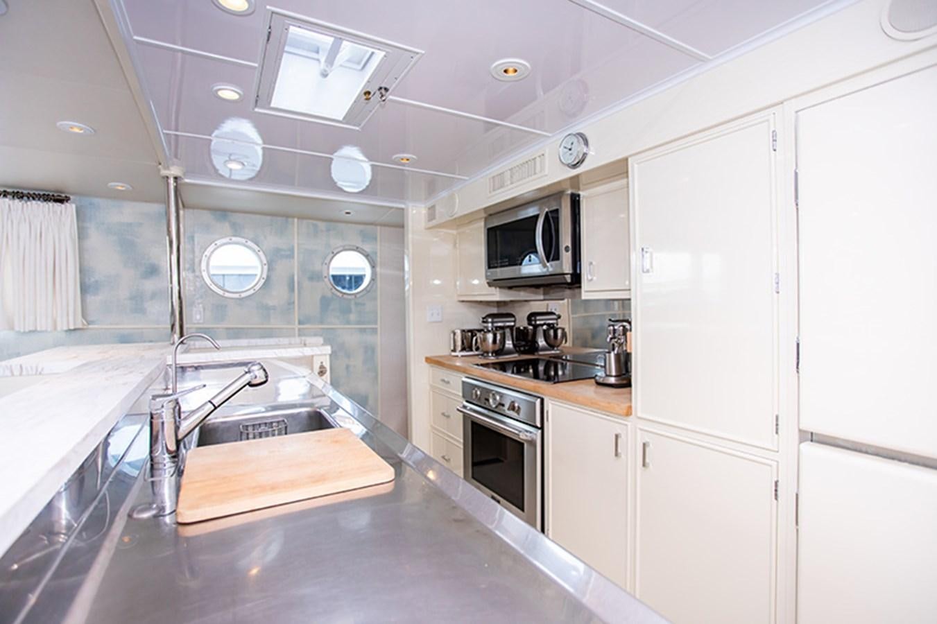 a kitchen with white cabinets aboard SOVEREIGN Yacht for Sale