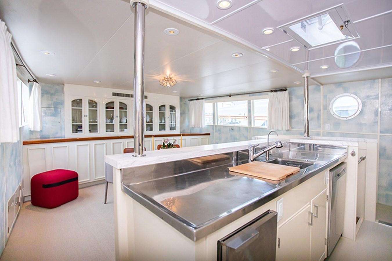 a kitchen with a large island aboard SOVEREIGN Yacht for Sale