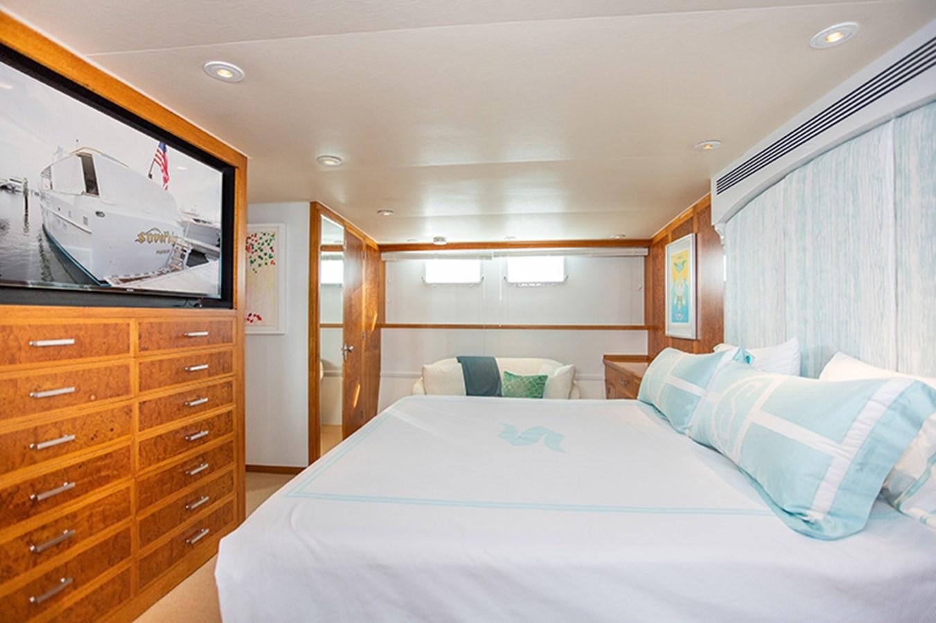 a bedroom with a bed and a television aboard SOVEREIGN Yacht for Sale