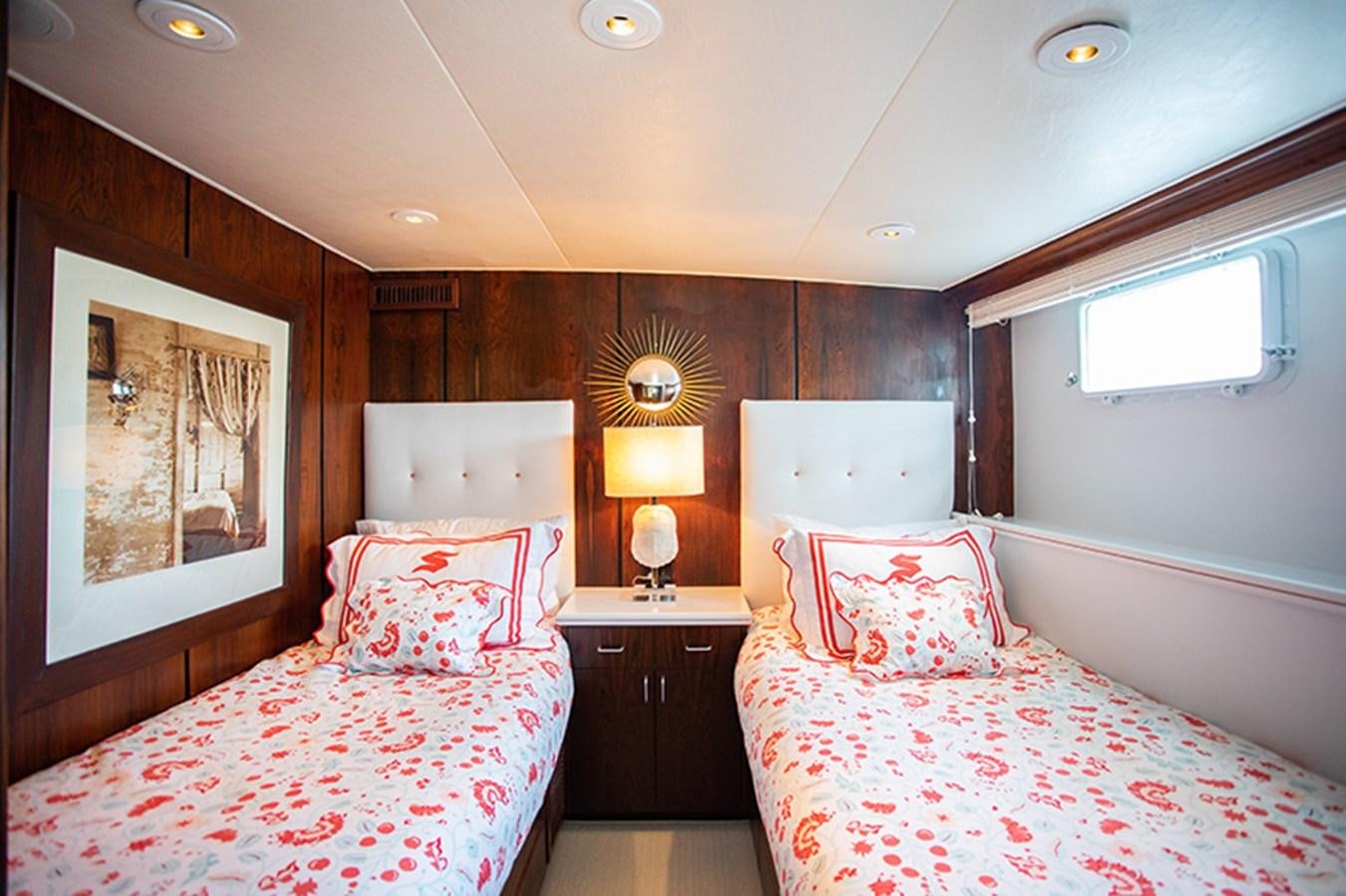 a couple of beds in a hotel room aboard SOVEREIGN Yacht for Sale