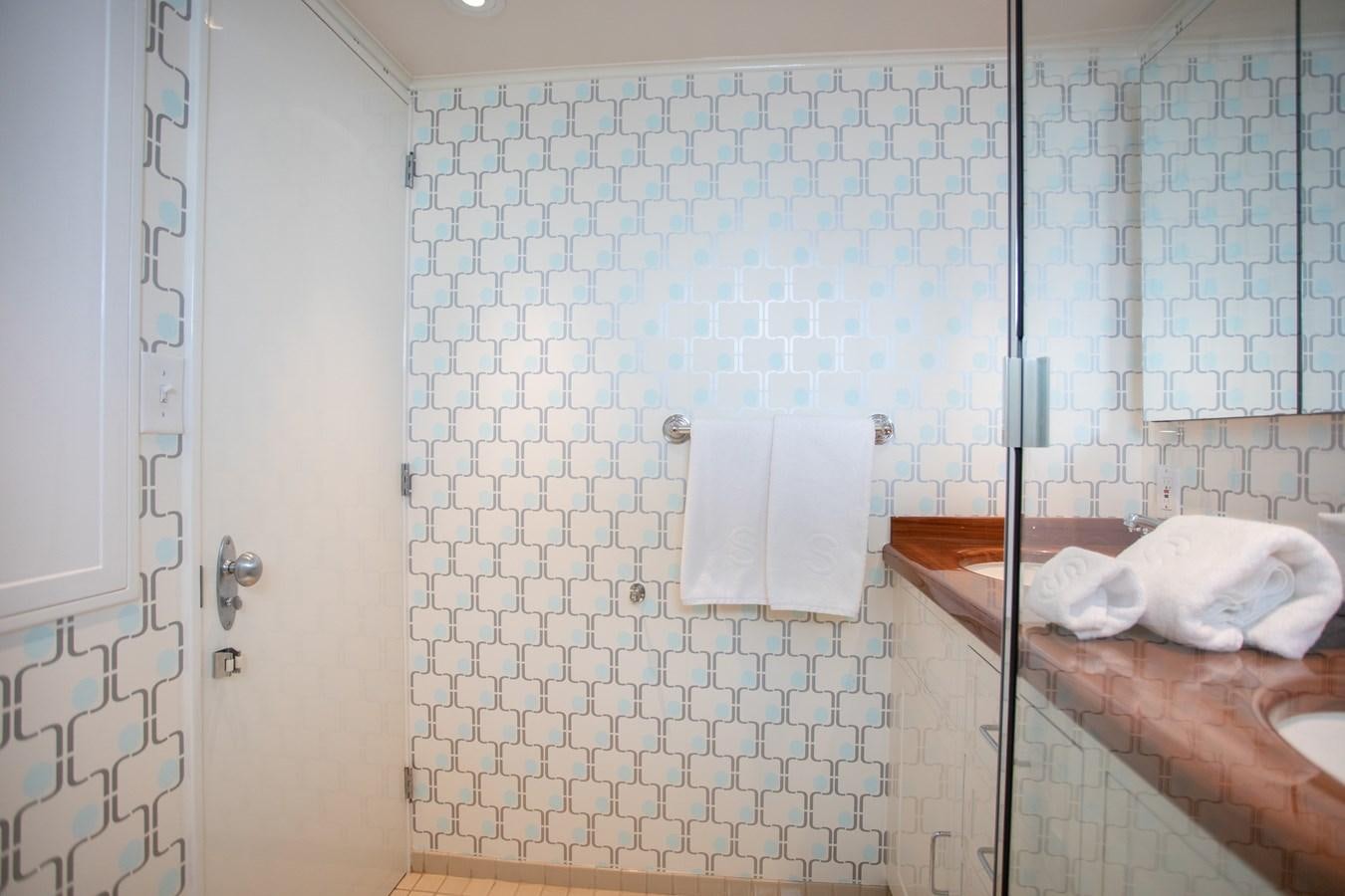 a bathroom with a shower curtain aboard SOVEREIGN Yacht for Sale