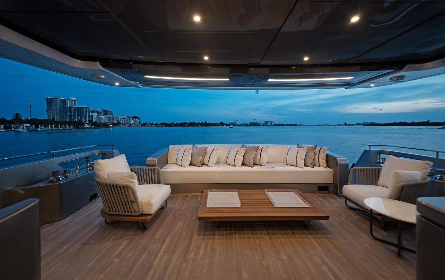 a room with a wood floor and a large sofa and a large window overlooking a city aboard ALLEGRA  @ AVENTURA Yacht for Sale