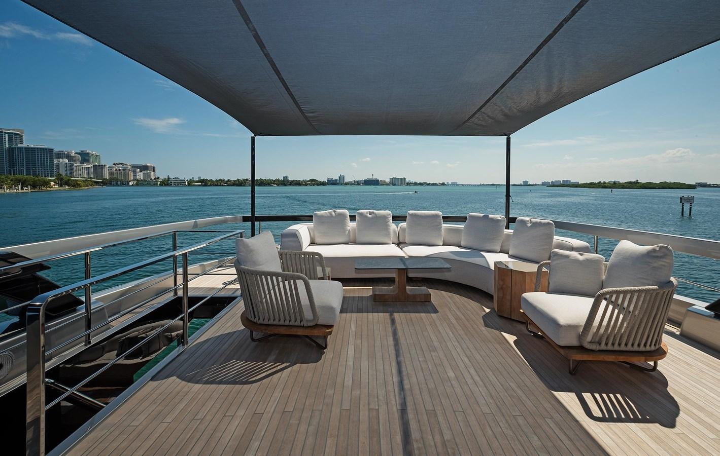 a deck with chairs and a body of water in the background aboard ALLEGRA  @ AVENTURA Yacht for Sale
