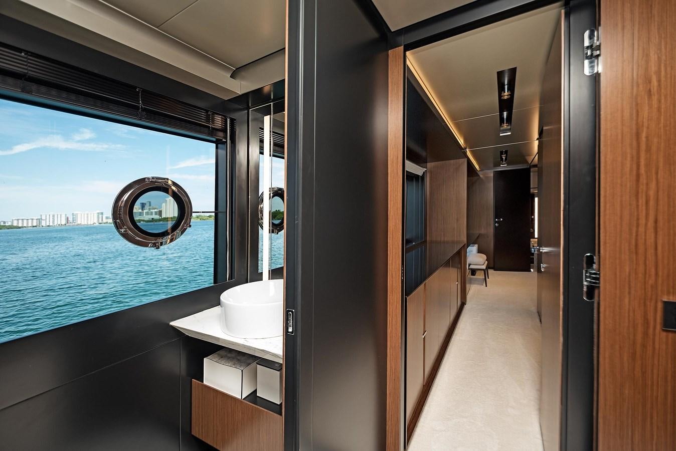 a bathroom with a large blue swimming pool aboard ALLEGRA  @ AVENTURA Yacht for Sale